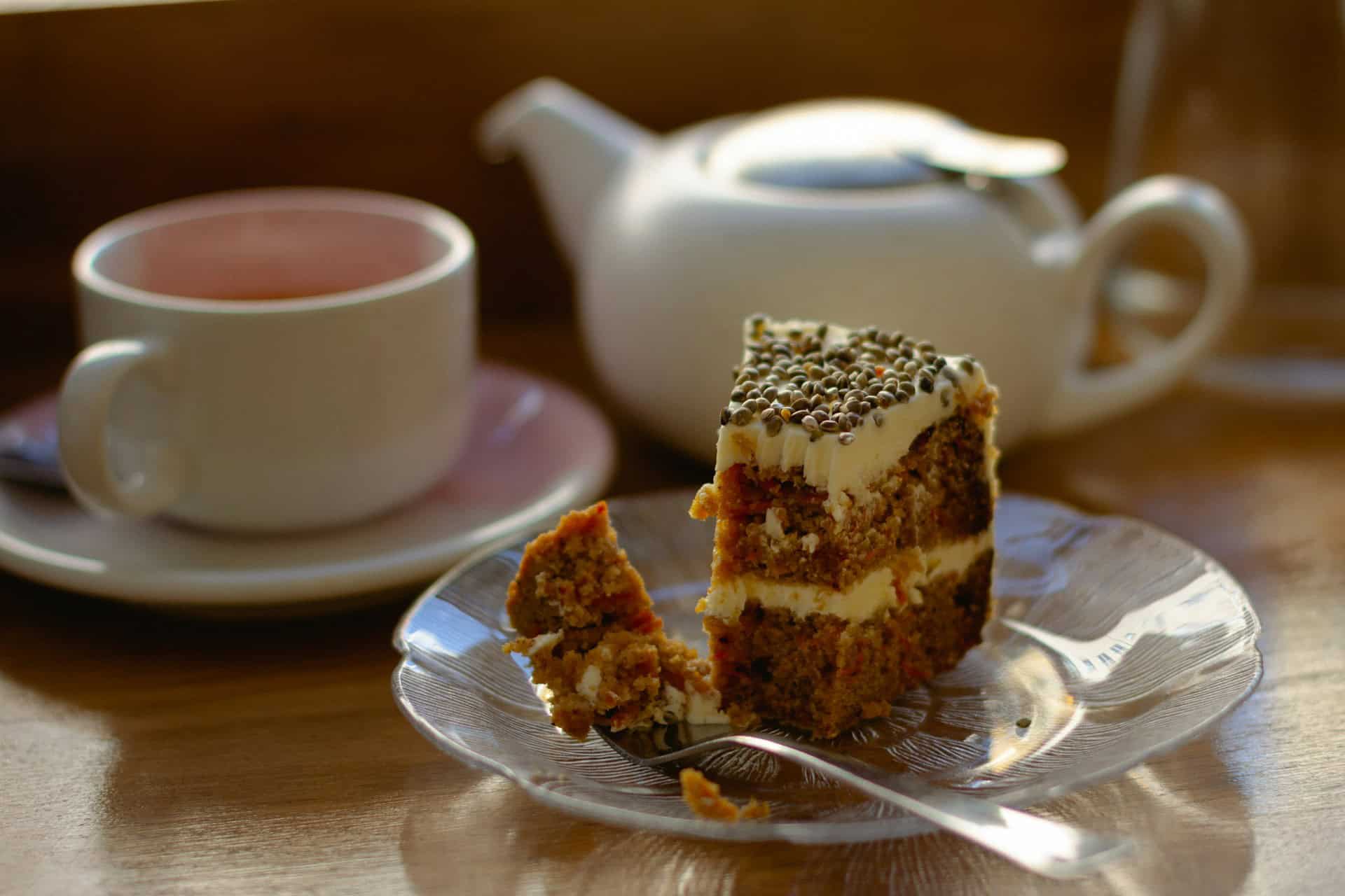 Worcester Whitehouse Hotel Afternoon Tea in Worcester Blog Image Close up of cake with teapot and cup inthe background